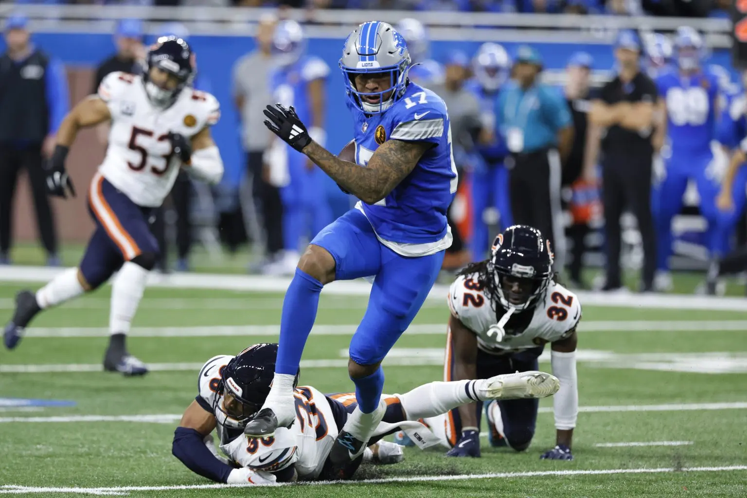 A ball carrier breaking a tackle during a football game